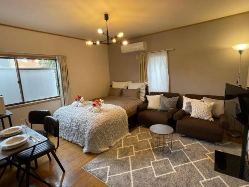 a living room with a couch and a table at Best Shinjuku Modern Full-furnished Apartment2 ONLY 2min to Shinjuku by Train in Tokyo