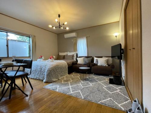 a bedroom with a bed and a living room at Best Shinjuku Modern Full-furnished Apartment2 ONLY 2min to Shinjuku by Train in Tokyo