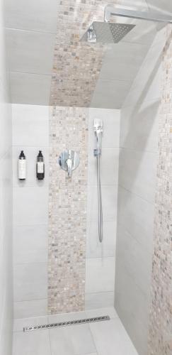 a bathroom with a shower with a shower head at Apartments The Space in Drawsko Pomorskie