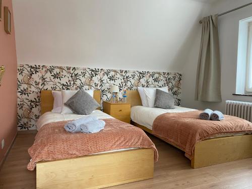 a bedroom with two beds with towels on them at La maison du bienvenu in Namur