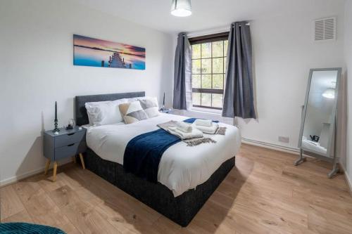 a bedroom with a large bed and a mirror at Fabulous apartment in the heart of Shoreditch in London