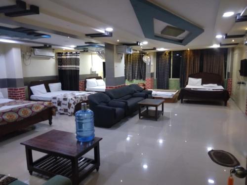 a large living room with a couch and a table at Haritha Apartments in Tirupati