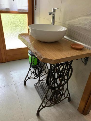 a large bowl sink on a wooden table in a bathroom at "La Pepita" di Pietro Bertolotti in Spagna