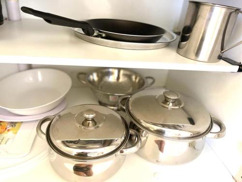 a kitchen counter top with two pots and pans at COMPLEJO ECHAGUE in San Juan