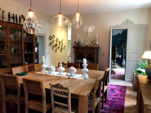 a dining room with a wooden table and chairs at La Gironnerie in Loché-sur-Indrois