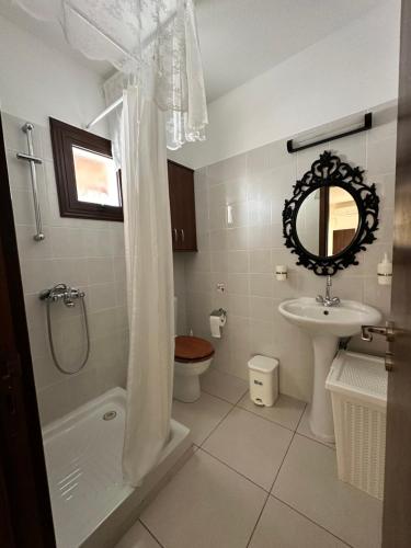 a bathroom with a shower and a sink and a toilet at Estia Vasilis Manoli in Ayia Napa