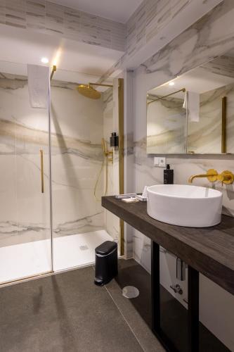 a bathroom with a tub and a sink and a shower at Hotel Sol Boutique in Santander