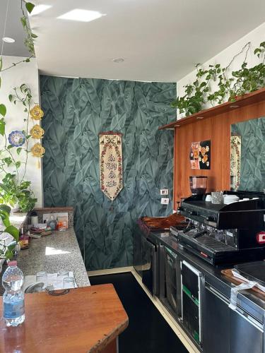 a kitchen with a stove and a green wall at Residence Politecnico Bovisa in Milan