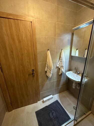 y baño con ducha y lavamanos. en Cosy apartments with sea view in complex PANORAMA en Chernomorets