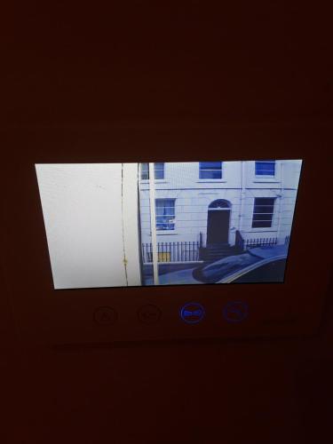 a television screen with a picture of a building at Jaskar studio 2 in Cheltenham