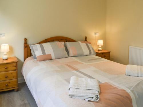a bedroom with a large bed with towels on it at Willow Tree Farm in Sutton on Sea