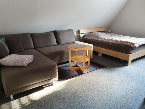 a living room with a couch and a bed at Schöne Doppelzimmer in Rheine