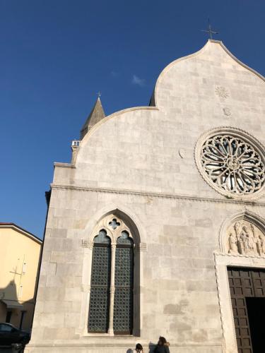 a large white church with a large window on it at La Tana di Alice in Muggia
