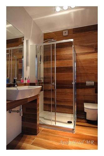 a bathroom with a shower and a sink and a toilet at Apartamenty Piła in Piła