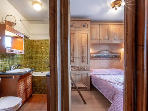 a small bathroom with a bed and a sink at Appartement La Clusaz, 3 pièces, 6 personnes - FR-1-437-44 in La Clusaz