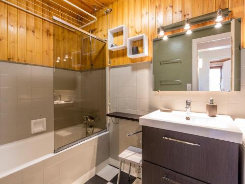 a bathroom with a sink and a mirror and a tub at Appartement La Clusaz, 3 pièces, 6 personnes - FR-1-437-59 in La Clusaz