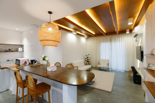 a kitchen and living room with a table and chairs at Grow home -Stay and space, Self check-in in Chiang Rai
