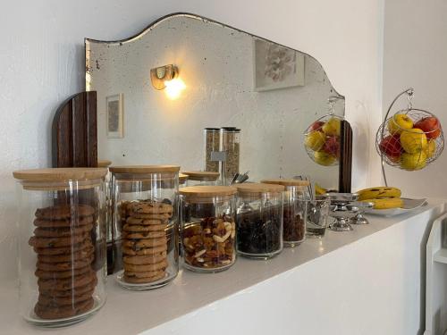 a shelf with glass jars of food on it at Hôtel Eden - La Baigneuse in Juan-les-Pins