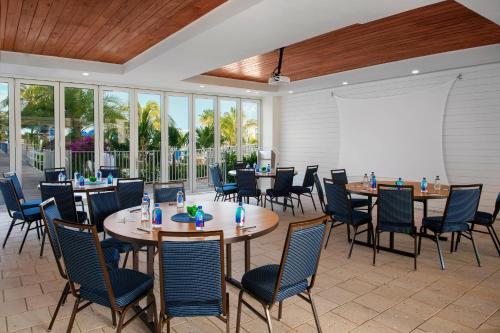 a dining room with tables and chairs and a whiteboard at Courtyard by Marriott Faro Blanco Resort in Marathon