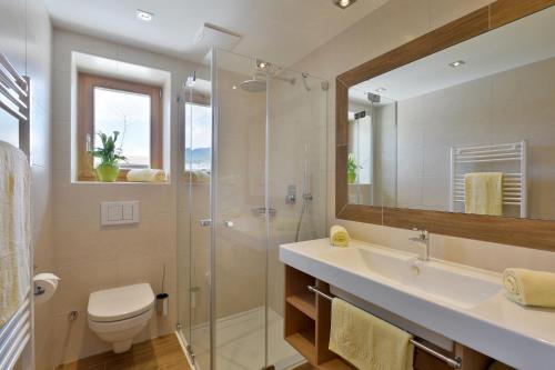エルマウにあるAppartementhaus Spiegl by Travel Partnerのシャワー、洗面台、トイレ付きのバスルーム