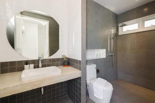 a bathroom with a sink and a toilet and a mirror at Grow home -Stay and space, Self check-in in Chiang Rai
