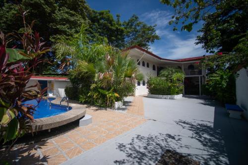 an exterior view of a house with a swimming pool at La Perlita in Jacó
