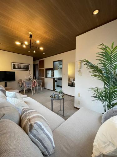 a living room with a couch and a table at Best Shinjuku Modern Full-furnished Family size Apartment3 ONLY 2min to Shinjuku by Train in Tokyo