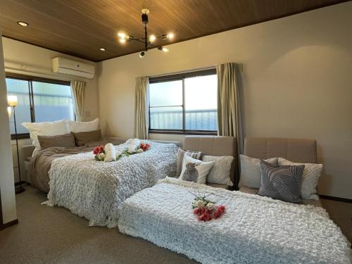 a bedroom with two beds with flowers on them at Best Shinjuku Modern Full-furnished Family size Apartment3 ONLY 2min to Shinjuku by Train in Tokyo