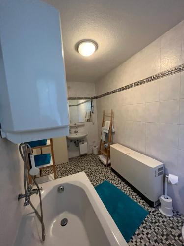a bathroom with a bath tub and a sink at Ferienwohnung Schlossberg 2 in Wirsberg