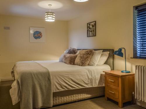 a bedroom with a bed with a stuffed animal on it at Bolivar Barn in Gwennap