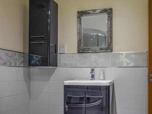 a bathroom with a sink and a mirror at Bolivar Barn in Gwennap