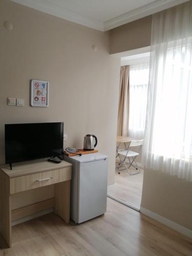 TV a/nebo společenská místnost v ubytování REGA OTEL