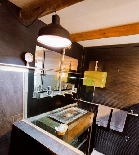 a bathroom with a sink and a mirror at Pousada Lua de Charme in Canoa Quebrada
