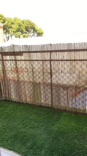 a wooden fence with green grass behind it at AMORE MÍO Hellín in Hellín
