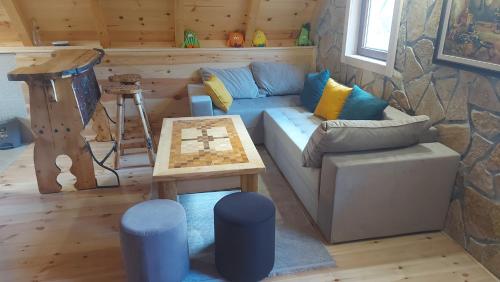 a living room with a blue couch and a table at Vila Verusa 2 in Podgorica
