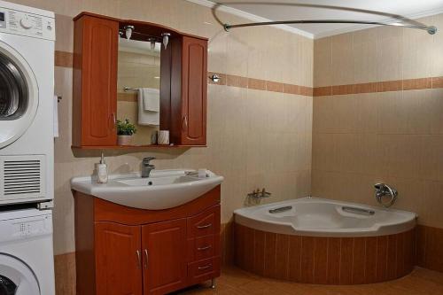 a bathroom with a sink and a washing machine at Villa Gray in Ixia