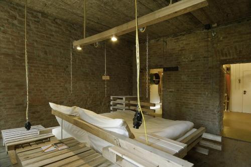 a bedroom with two beds in a brick wall at Wiener Gäste Zimmer in Vienna