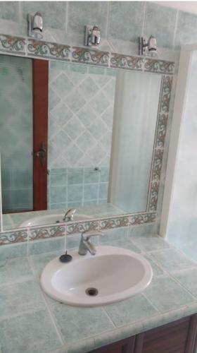 a bathroom with a sink and a mirror at Appartamento Le Margherite in Procida