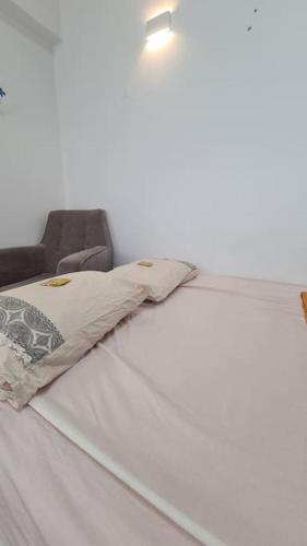 a bed with a light on top of it at Bright Studio in Shapira in Tel Aviv