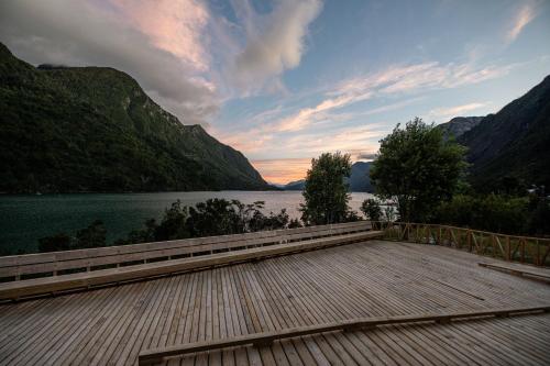 a dock with a view of a lake and mountains at Tawa Refugio del Puelo in Puelo