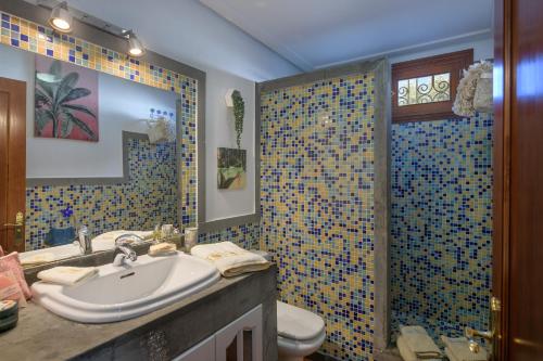 een badkamer met een wastafel, een toilet en een douche bij Beautiful Boho Glam Villa With Private Pool in Playa Blanca