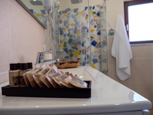 a white counter top with a tray of food on it at Sicilia Bedda - B&B - Rooms - Apartments in Santo Stefano di Camastra