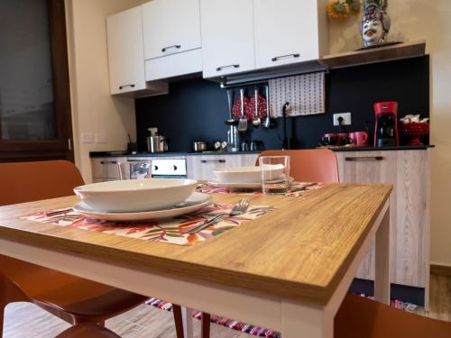 a kitchen with a wooden table with dishes on it at Sicilia Bedda - B&B - Rooms - Apartments in Santo Stefano di Camastra