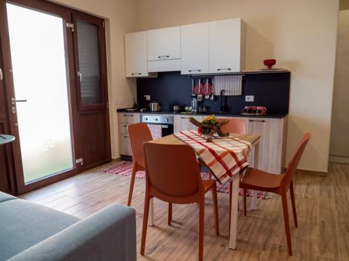 a kitchen with a table and chairs in a room at Sicilia Bedda - B&B - Rooms - Apartments in Santo Stefano di Camastra