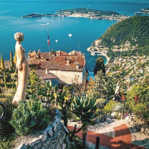 a statue of a woman standing on top of a mountain at Studio tout confort avec parking et terrasse à Eze village in Éze