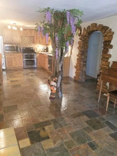 a kitchen with a vase with purple flowers in it at Your comfy home in Colorado Springs in Colorado Springs