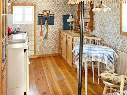 a kitchen with a sink and a table in it at 5 person holiday home in BODAFORS-By Traum in Bodafors