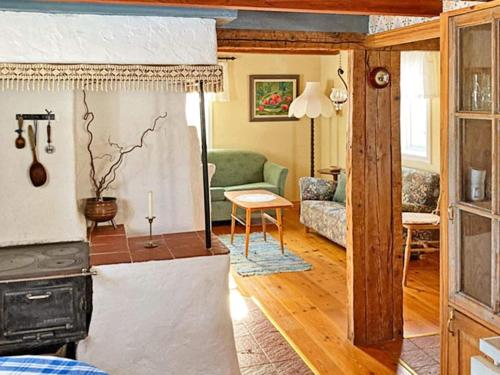 a living room with a couch and a stove at 5 person holiday home in BODAFORS-By Traum in Bodafors