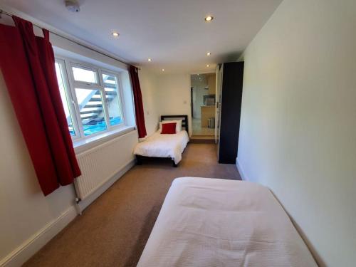 a small bedroom with a bed and a window at Central Windsor 2 bedroom flat with free parking in Windsor