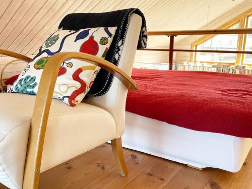 a bedroom with a bed and a chair with a pillow at 6 person holiday home in HAMMARÖ-By Traum in Hammarö